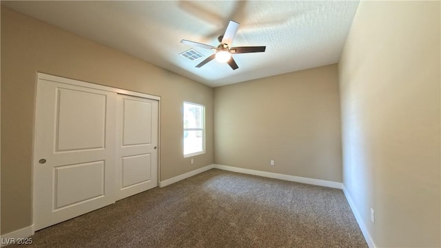 unfurnished bedroom featuring visible vents, carpet flooring, and baseboards