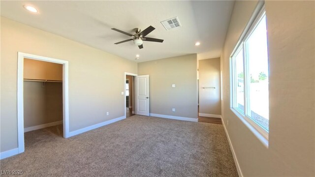 1931 Rose Ct, Pahrump, NV 89048 - unfurnished bedroom with carpet floors, recessed lighting, a walk in closet, and a ceiling fan