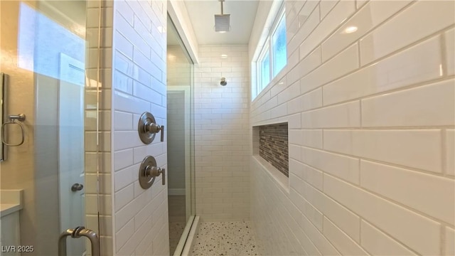 full bathroom featuring tile walls and a shower stall
