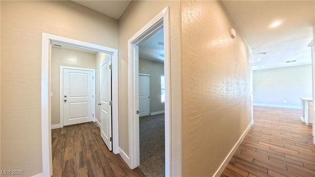 hallway with baseboards and dark wood finished floors