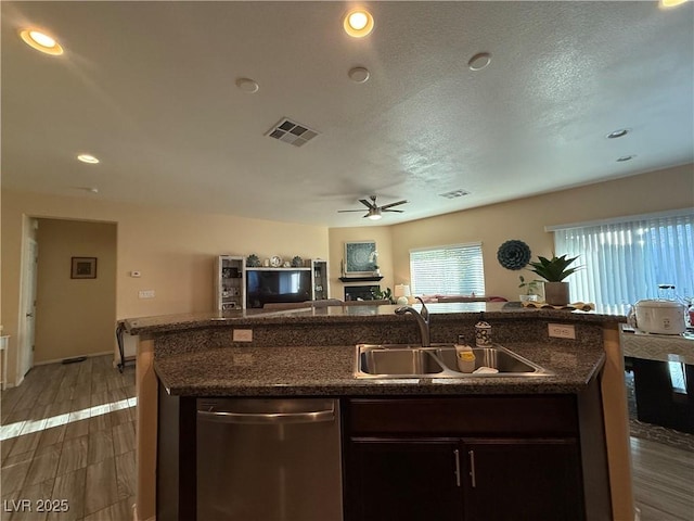 4837 Skyraider St, North Las Vegas, NV 89031 - kitchen with stainless steel dishwasher, a sink, ceiling fan, open floor plan, and a kitchen island with sink