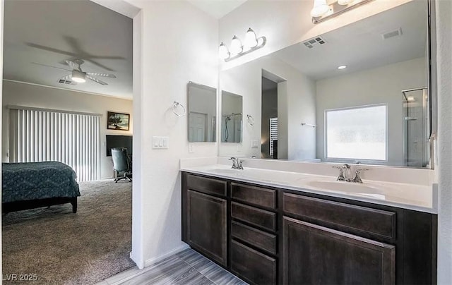 4837 Skyraider St, North Las Vegas, NV 89031 - bathroom with a ceiling fan, double vanity, ensuite bath, a shower, and baseboards