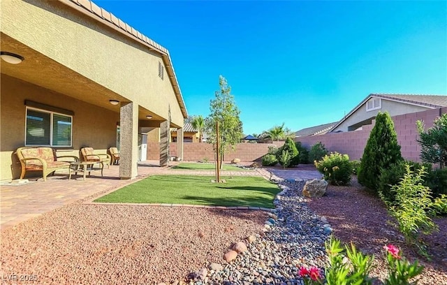 4837 Skyraider St, North Las Vegas, NV 89031 - fenced backyard featuring a patio area and outdoor lounge area