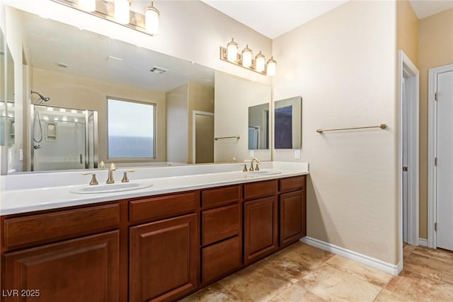 full bathroom featuring a shower with door, a sink, and visible vents