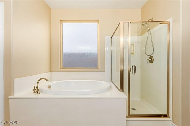 full bath featuring a shower stall and a garden tub