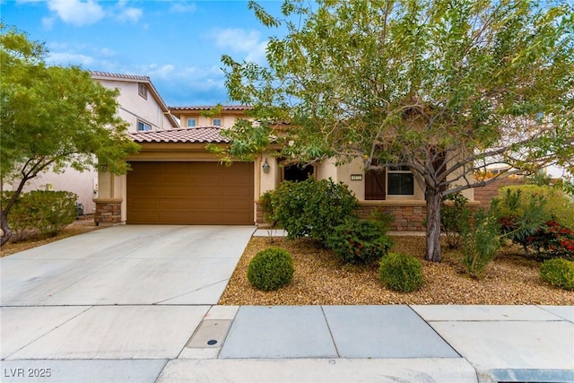 mediterranean / spanish-style home featuring stone siding, a garage, a tile roof, stucco siding, and driveway