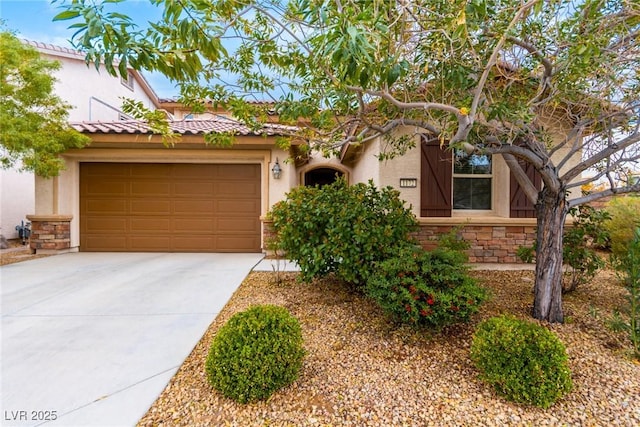 mediterranean / spanish-style house with an attached garage, driveway, stucco siding, and stone siding