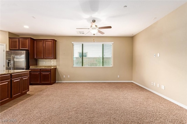 kitchen with light carpet, stainless steel refrigerator with ice dispenser, decorative backsplash, and ceiling fan