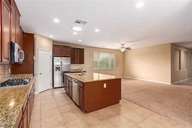 kitchen with light carpet, visible vents, ceiling fan, stainless steel appliances, and a sink