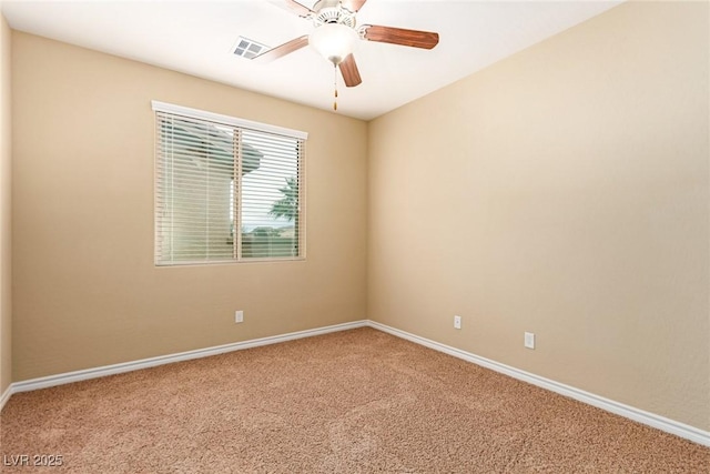 carpeted empty room featuring baseboards, a ceiling fan, and visible vents