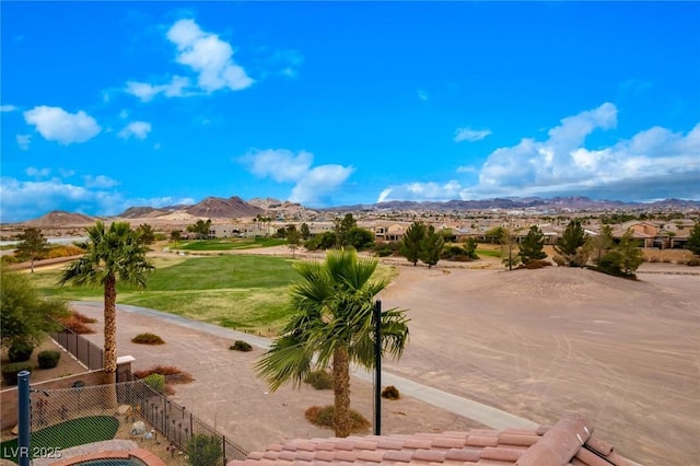 view of home's community with fence and a mountain view
