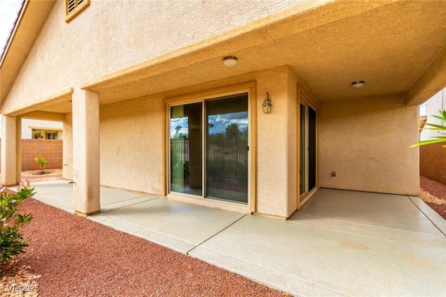 view of patio featuring fence