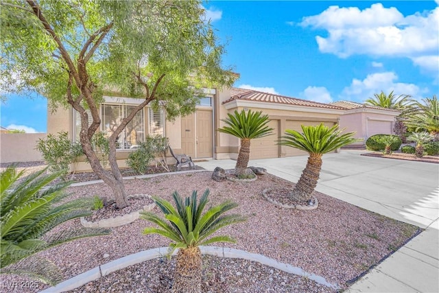 9155 Bush Poppy Ave, Las Vegas, NV 89147 - view of front of home featuring driveway, stucco siding, an attached garage, and a tile roof