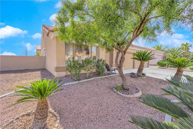 9155 Bush Poppy Ave, Las Vegas, NV 89147 - view of front of home with stucco siding, concrete driveway, an attached garage, and fence