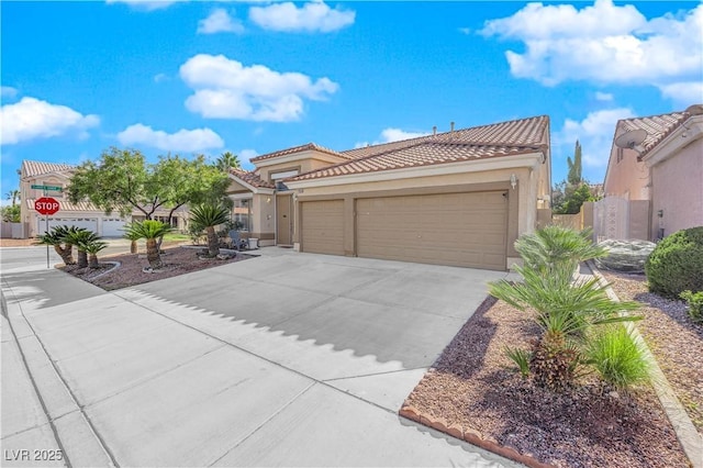 9155 Bush Poppy Ave, Las Vegas, NV 89147 - mediterranean / spanish house featuring a tiled roof, driveway, stucco siding, and an attached garage