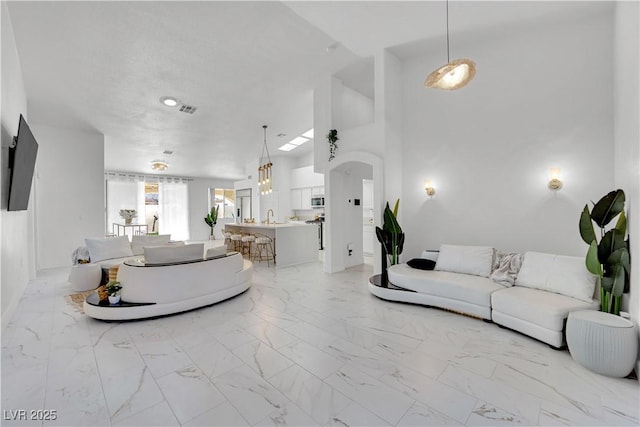 9155 Bush Poppy Ave, Las Vegas, NV 89147 - living room featuring light marble finish flooring