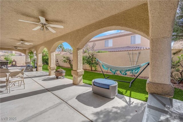 9155 Bush Poppy Ave, Las Vegas, NV 89147 - view of patio featuring a fenced backyard, ceiling fan, and a fire pit