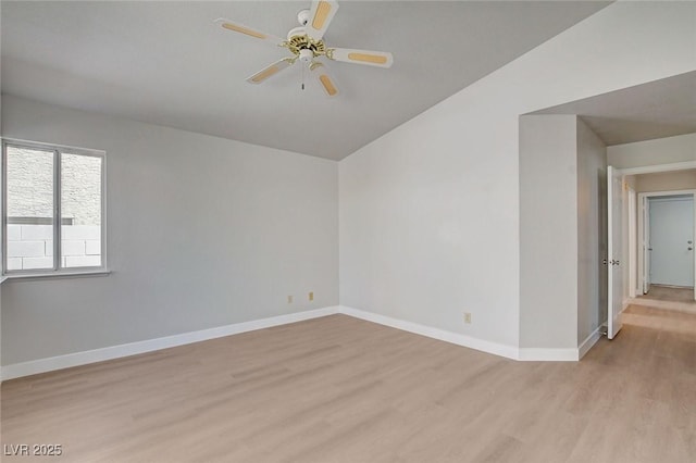 unfurnished room featuring vaulted ceiling, light wood-type flooring, baseboards, and ceiling fan