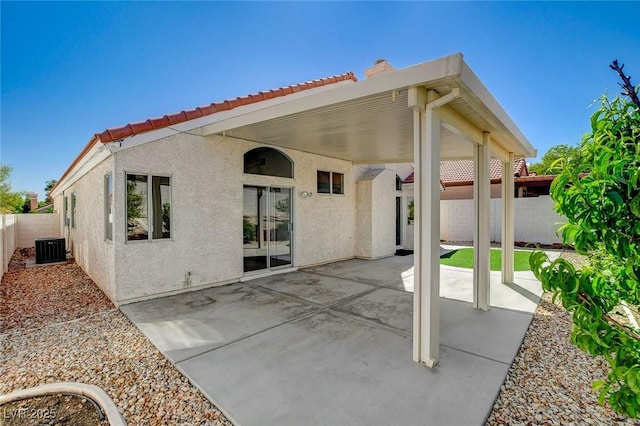 back of property featuring a patio, a fenced backyard, a tiled roof, and stucco siding
