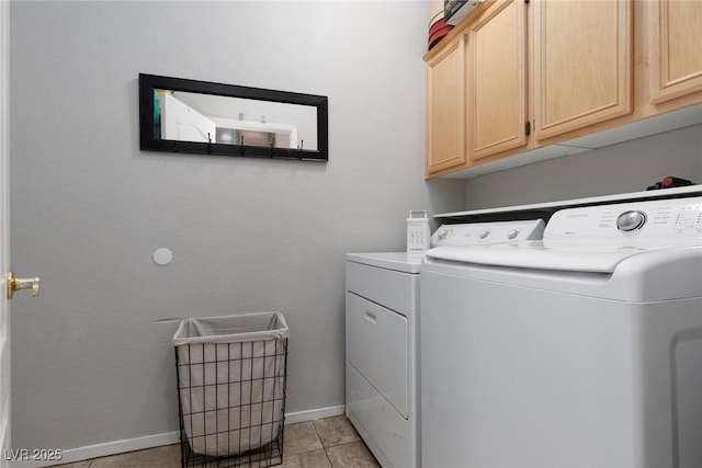 washroom with cabinet space, light tile patterned floors, baseboards, and separate washer and dryer