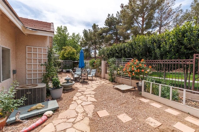view of patio / terrace featuring cooling unit and fence