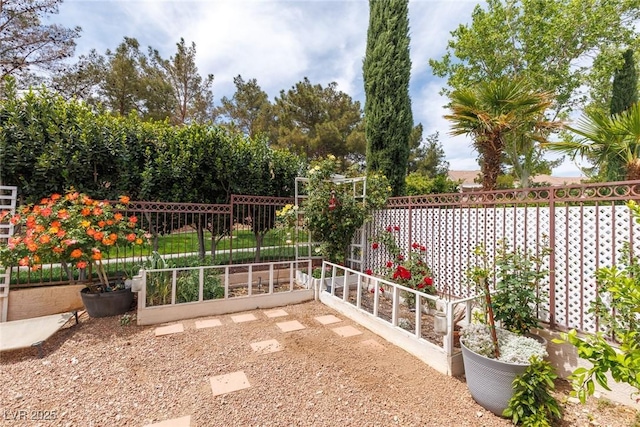 view of patio with fence and a vegetable garden