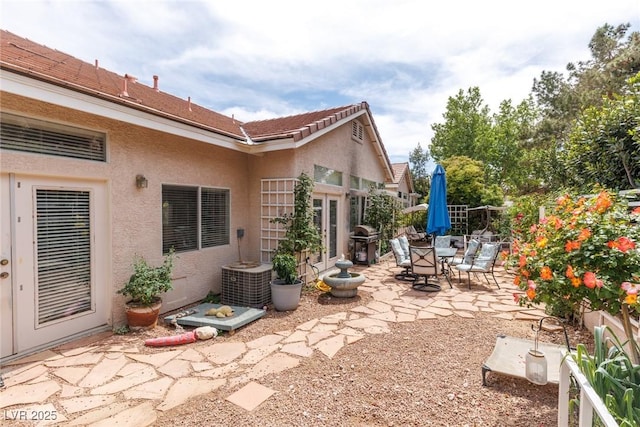 view of patio featuring grilling area and fence