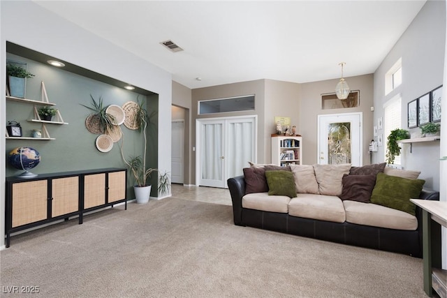 living room with visible vents and carpet floors
