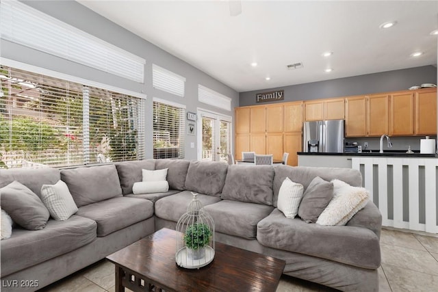 living area with light tile patterned flooring, visible vents, and recessed lighting