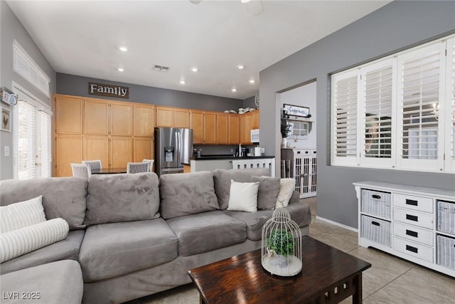 living room with recessed lighting, visible vents, baseboards, and light tile patterned flooring