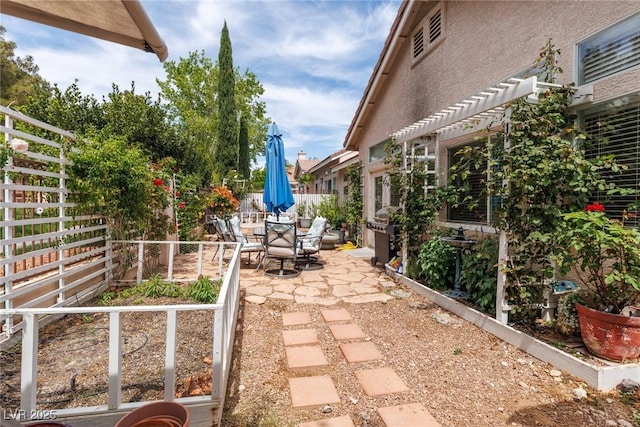 view of patio / terrace with a fenced backyard, outdoor dining space, and a pergola