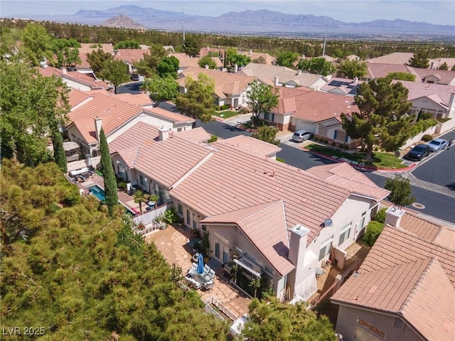 birds eye view of property with a mountain view and a residential view