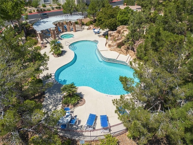 view of swimming pool featuring a patio area and a hot tub