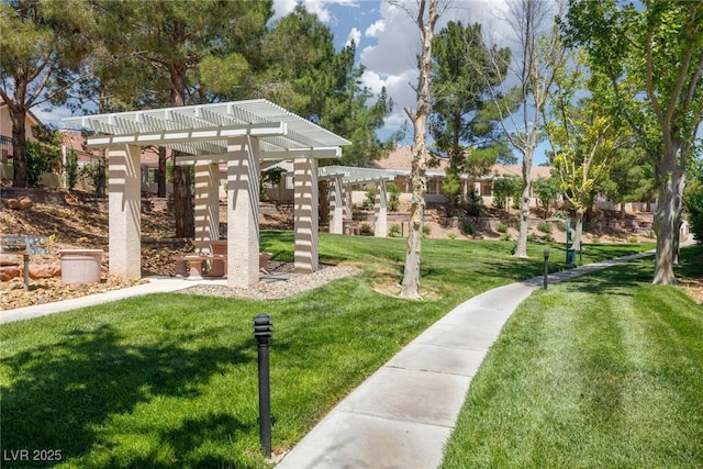view of home's community featuring a pergola and a yard