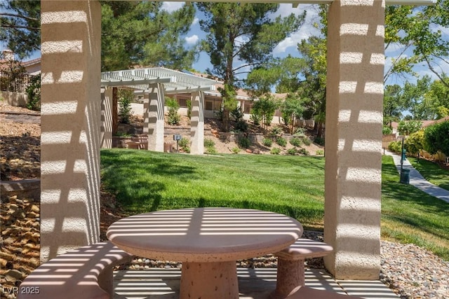 view of community featuring a yard and a pergola
