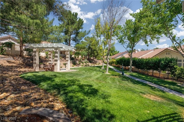 view of yard with fence and a pergola