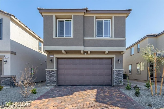 view of front of property with stucco siding, stone siding, decorative driveway, and an attached garage
