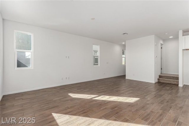 unfurnished living room featuring light wood-style flooring, recessed lighting, and a wealth of natural light