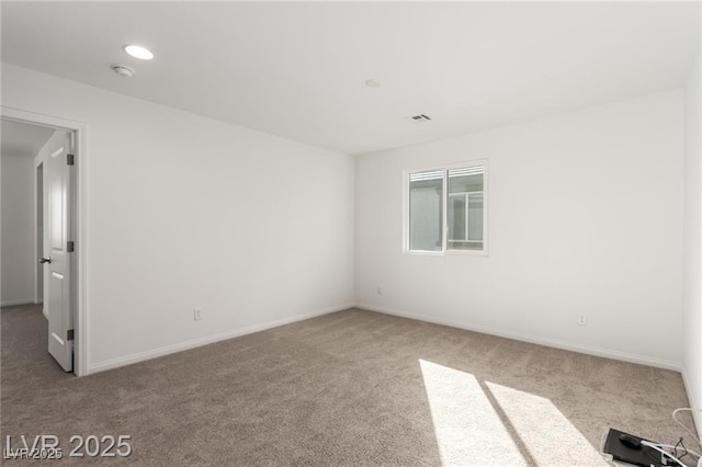 carpeted empty room with baseboards and visible vents