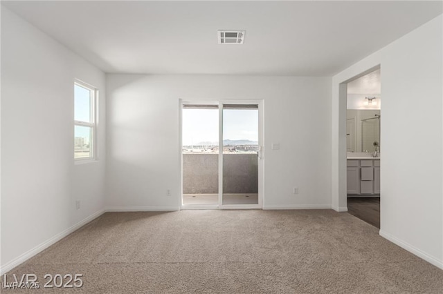 unfurnished bedroom with visible vents, baseboards, access to outside, and carpet