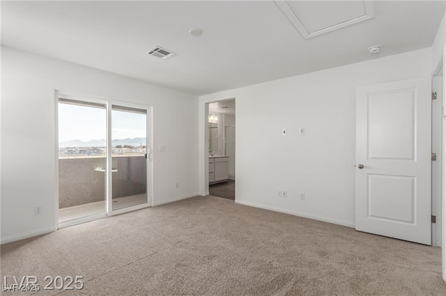 unfurnished bedroom with visible vents, access to exterior, carpet flooring, attic access, and baseboards