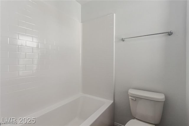 bathroom featuring shower / bathing tub combination and toilet