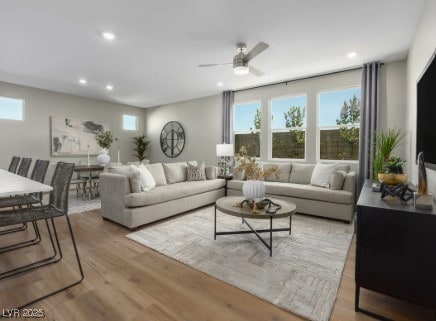 living room with a wealth of natural light, recessed lighting, and a ceiling fan