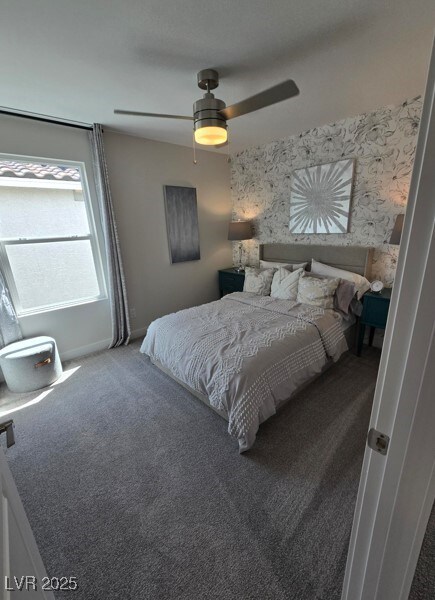 carpeted bedroom featuring ceiling fan and baseboards