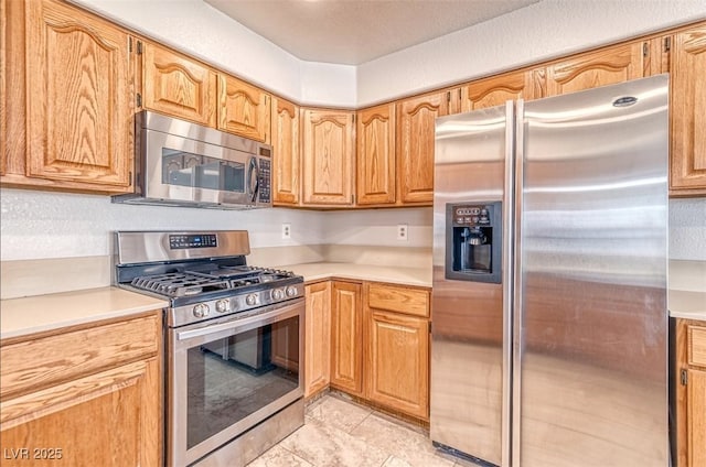 kitchen with stainless steel appliances and light countertops