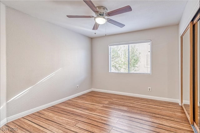 unfurnished bedroom with a closet, light wood finished floors, baseboards, and a ceiling fan