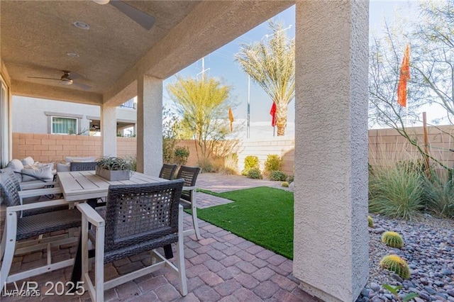 view of patio featuring ceiling fan, a fenced backyard, and outdoor dining area