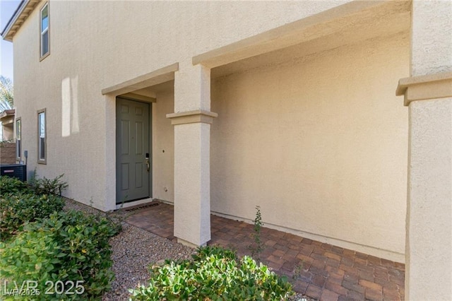 doorway to property with stucco siding