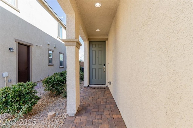 property entrance featuring stucco siding
