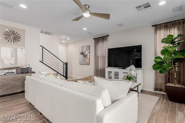 living area with recessed lighting, stairway, visible vents, wood finish floors, and ceiling fan